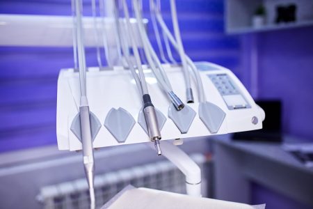 Modern metallic dentist tools and burnishers on a dentist chair in Dentist Clinic. Different dental instruments and tools in a dentists office.